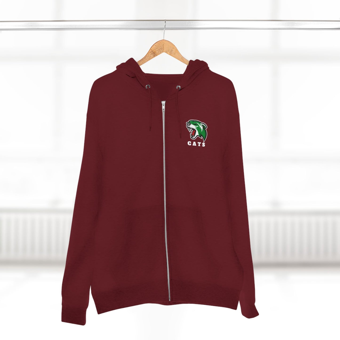 Burgundy Noah Boucher Toronto Fisher Cats Zip Hoodie on wooden hanger. Blurry white room as background