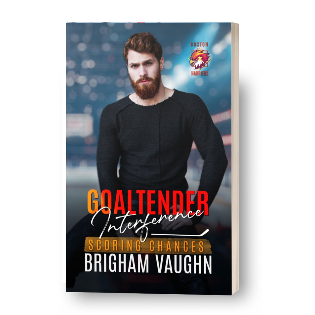 Signed paperback book cover featuring a man with auburn hair and beard and text saying 'Goaltender Interference' by Brigham Vaughn.