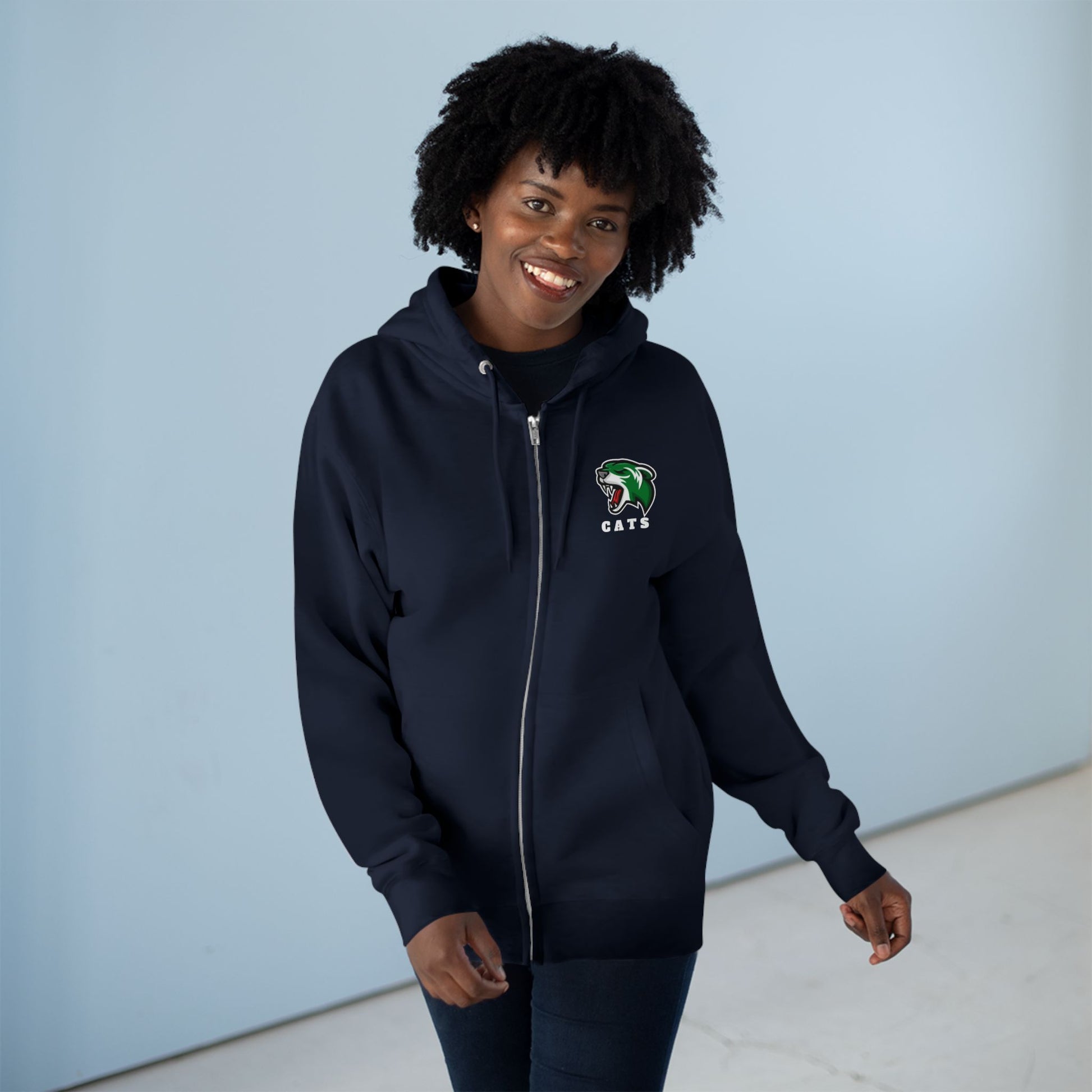 Woman with brown skin and natural black hair wearing Navy Noah Boucher Toronto Fisher Cats Zip Hoodie and jeans