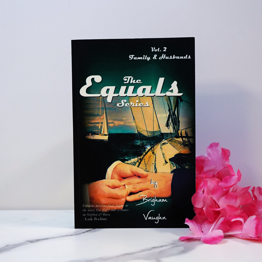 Signed paperback book titled 'The Equals Series Vol. 2' on a white surface with pink flowers.