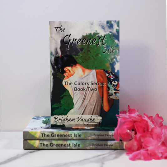 Signed paperback book titled 'The Greenest Isle' by Brigham Vaughn with pink flowers on a white background. 