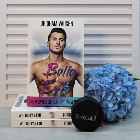 Signed paperback book titled 'Bully & Exit' by Brigham Vaughn with hockey puck and blue flowers on a light background