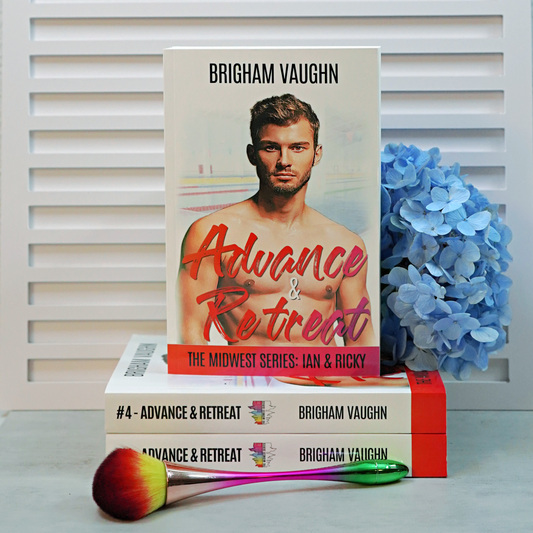 Stack of signed paperback books titled 'Advance & Retreat' by Brigham Vaughn with blue flowers and a makeup brush on a white background.