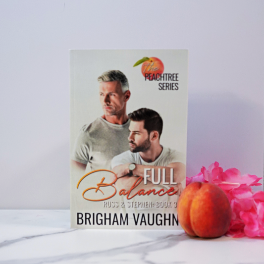 Signed paperback book cover of 'Full Balance' by Brigham Vaughn with a peach and pink flower on a white surface.