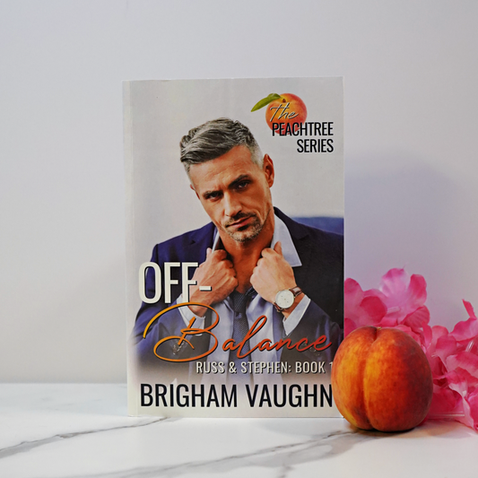 Signed paperback book cover of 'Off-Balance' by Brigham Vaughn with flowers and a peach against a white background.